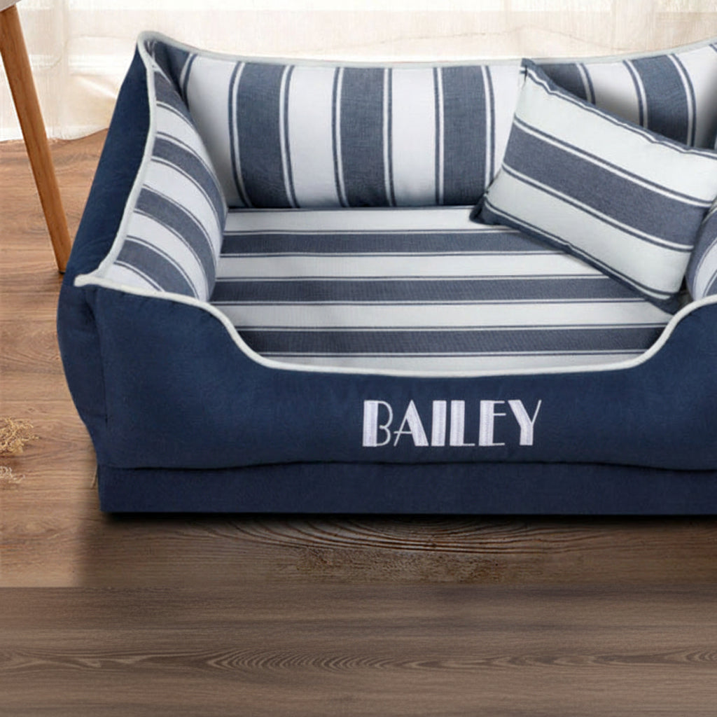 Blue and white striped pet bed with 'BEITUN' branding on a wooden floor.