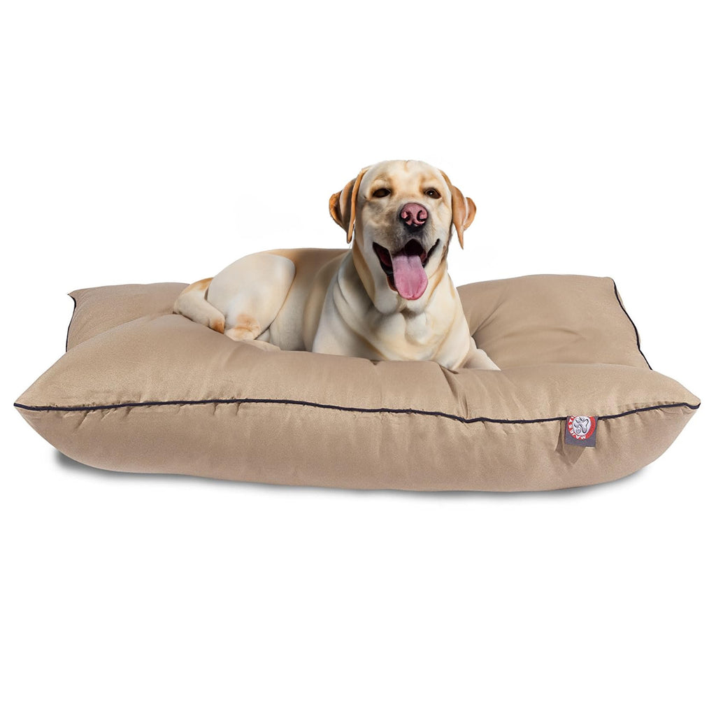 Dog lying on a beige dog bed with a visible brand logo on a white background