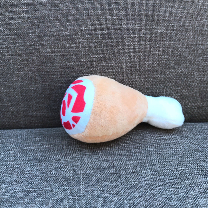 Plush toy resembling a drum on a gray textured surface