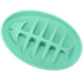 Green silicone mold shaped like a fish on a white background