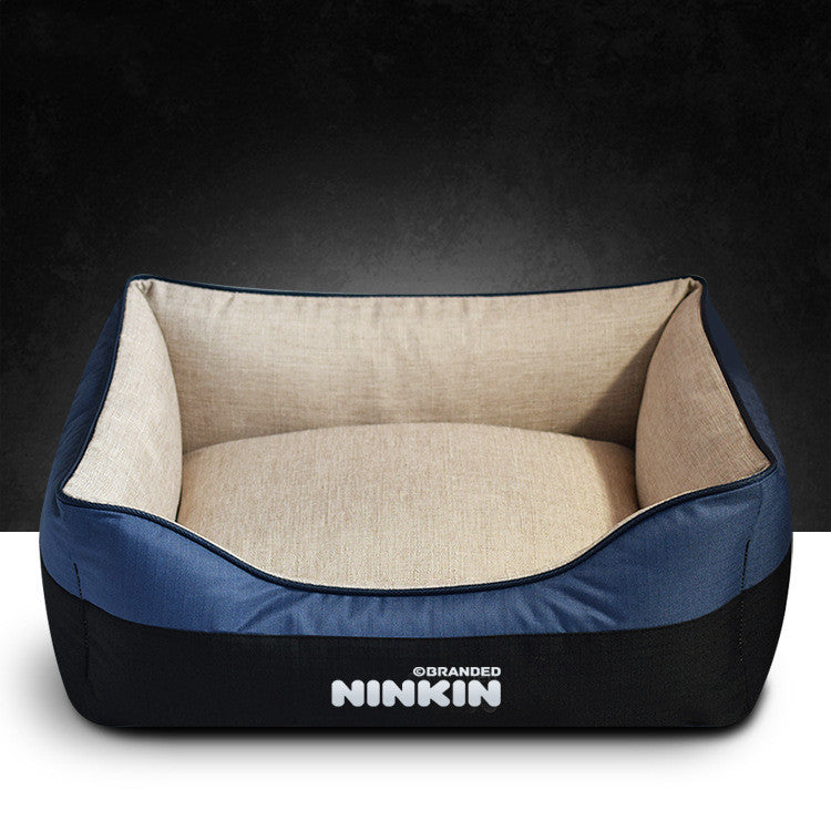 Pet bed with blue exterior and beige interior on a dark background