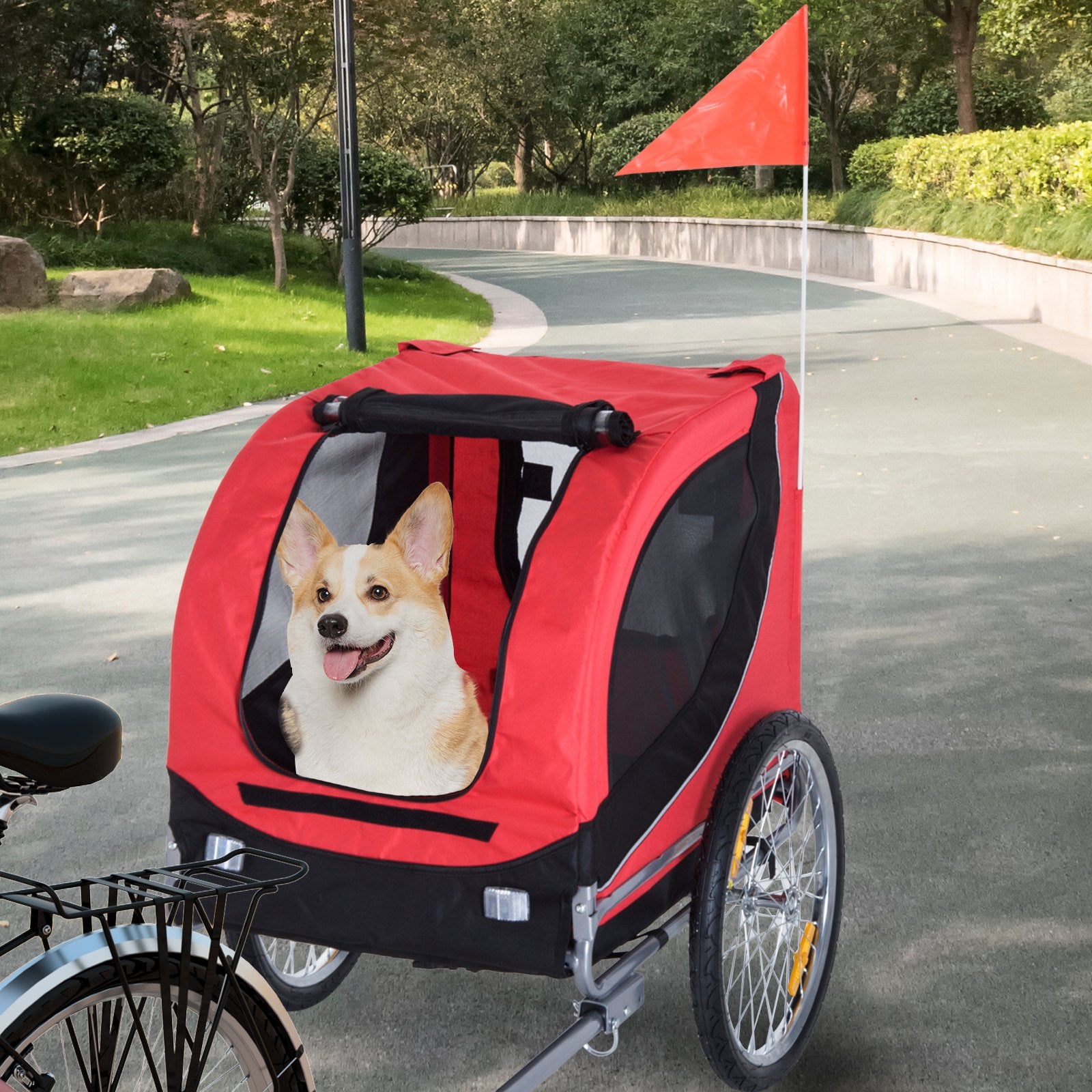 Red and black pet bike trailer with a dog inside, parked on a road.