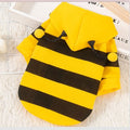Yellow and black striped hoodie with a hood on a light wooden surface.