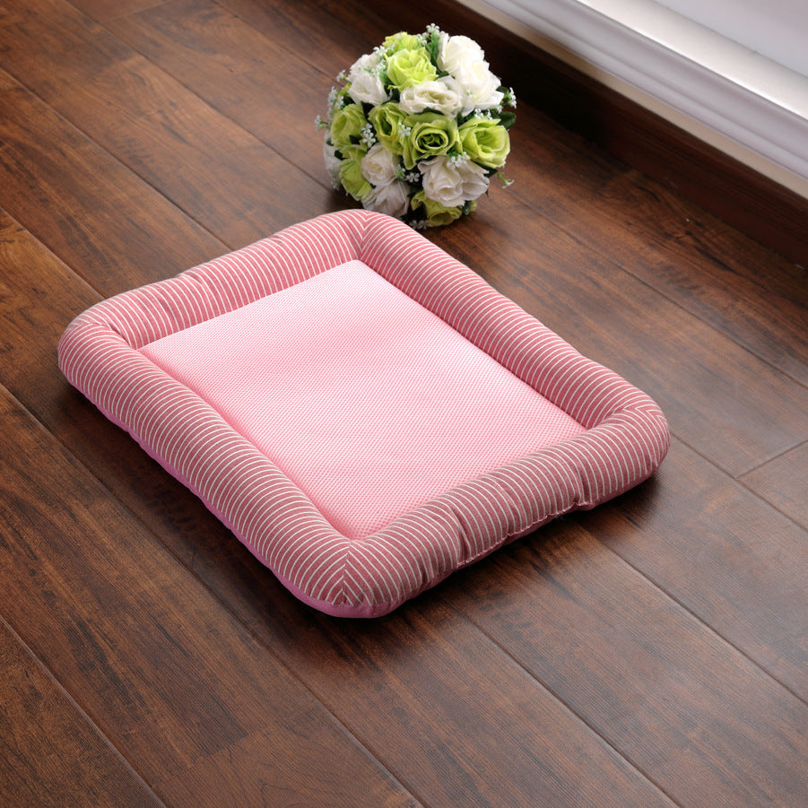Pink pet bed on a wooden floor with flowers in the background