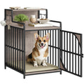 Dog inside a pet crate with a small table on top, featuring decorative items.