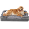 Dog lying on a gray pet bed with a white background