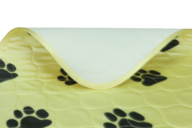 Yellow pet mat with black paw prints on a white background