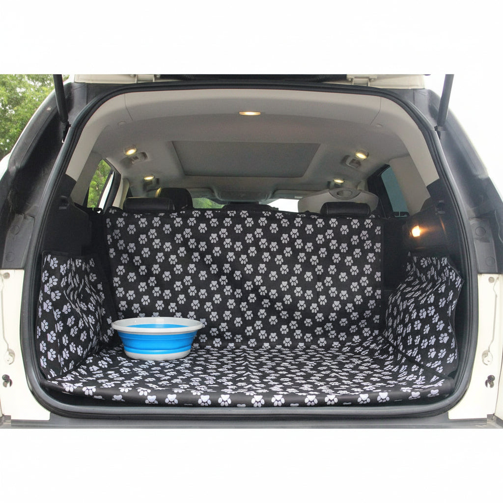 Car trunk with a black and white paw print cover and a blue bowl inside.