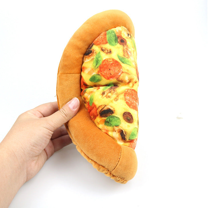 Hand holding a plush toy shaped like a pizza in a bun on a white background