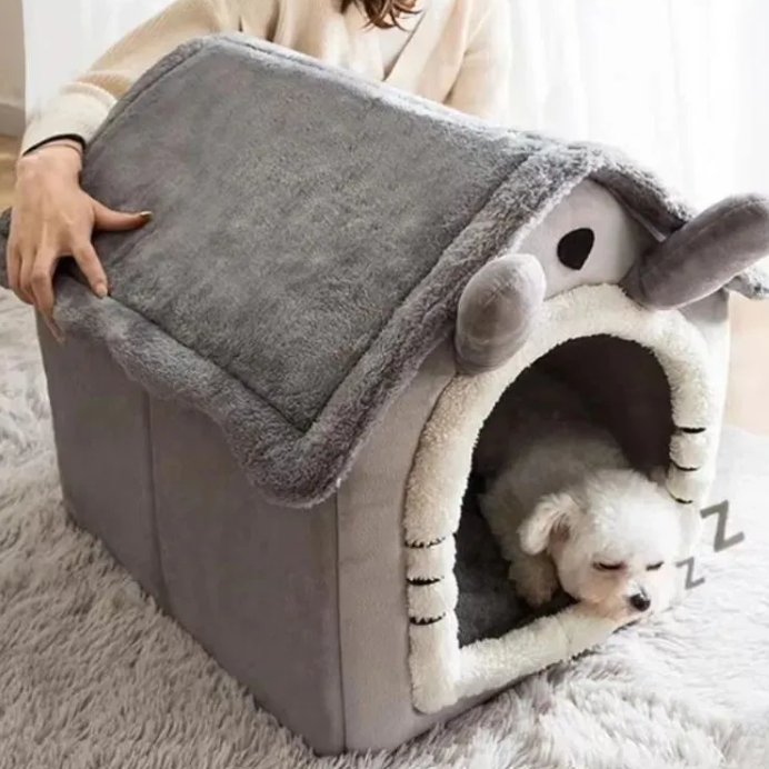 Dog lying in a gray pet house with a fluffy interior