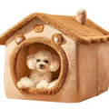Small white dog inside a beige pet house with a brown roof on a white background
