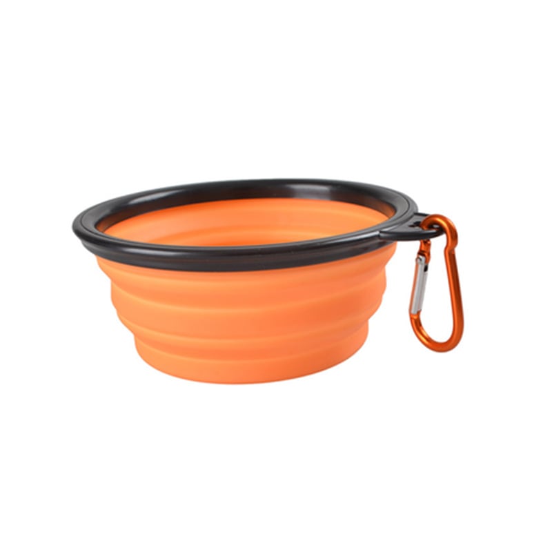 Orange collapsible dog bowl with black rim and carabiner on a white background
