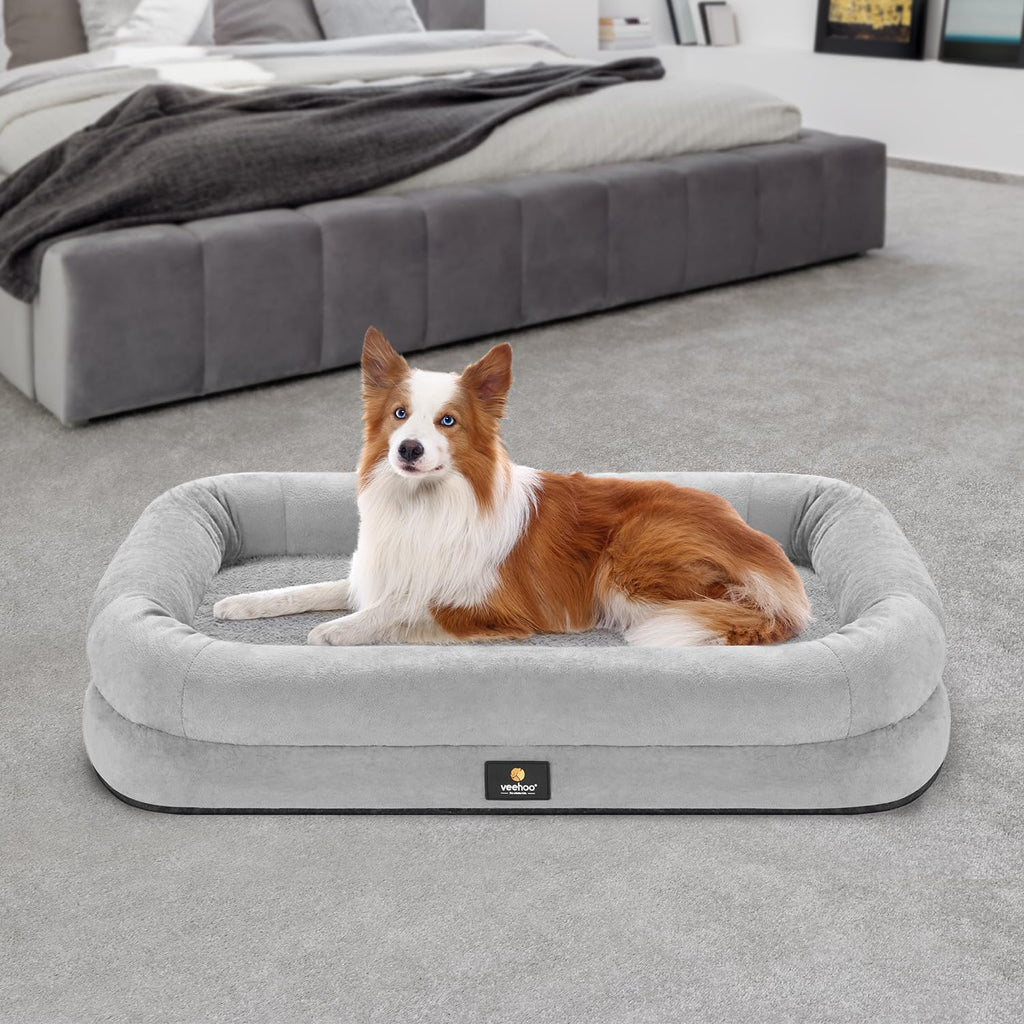 Dog lying on a gray pet bed in a bedroom