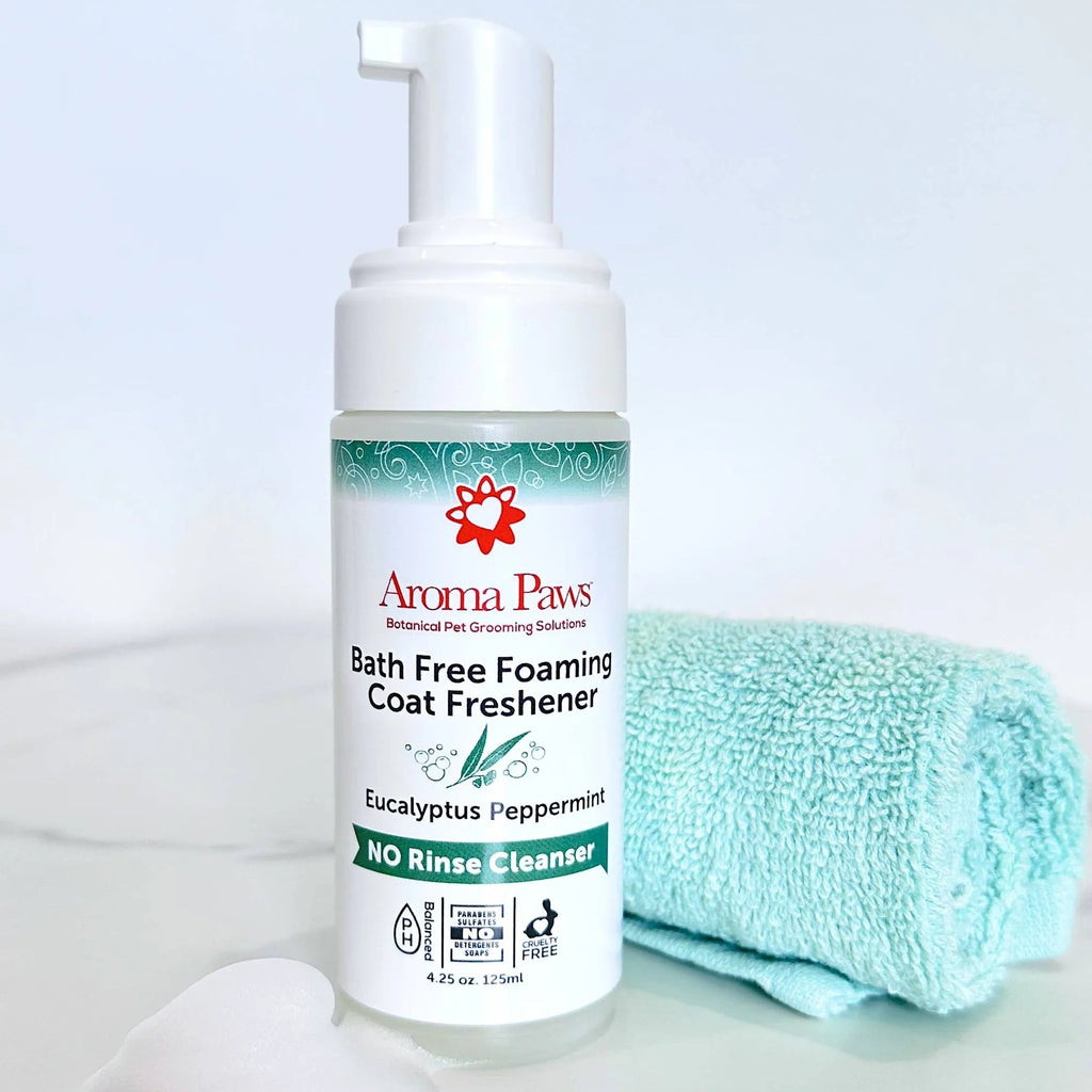 Aroma Paws Bath Free Foaming Coat Freshener bottle with a towel on a light background