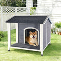 Doghouse with a dog inside on a grassy lawn