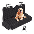 Black quilted car seat cover with a dog sitting on it, on a white background