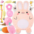 Set of dog toys including a plush rabbit, chew toy, and other items on a white background.