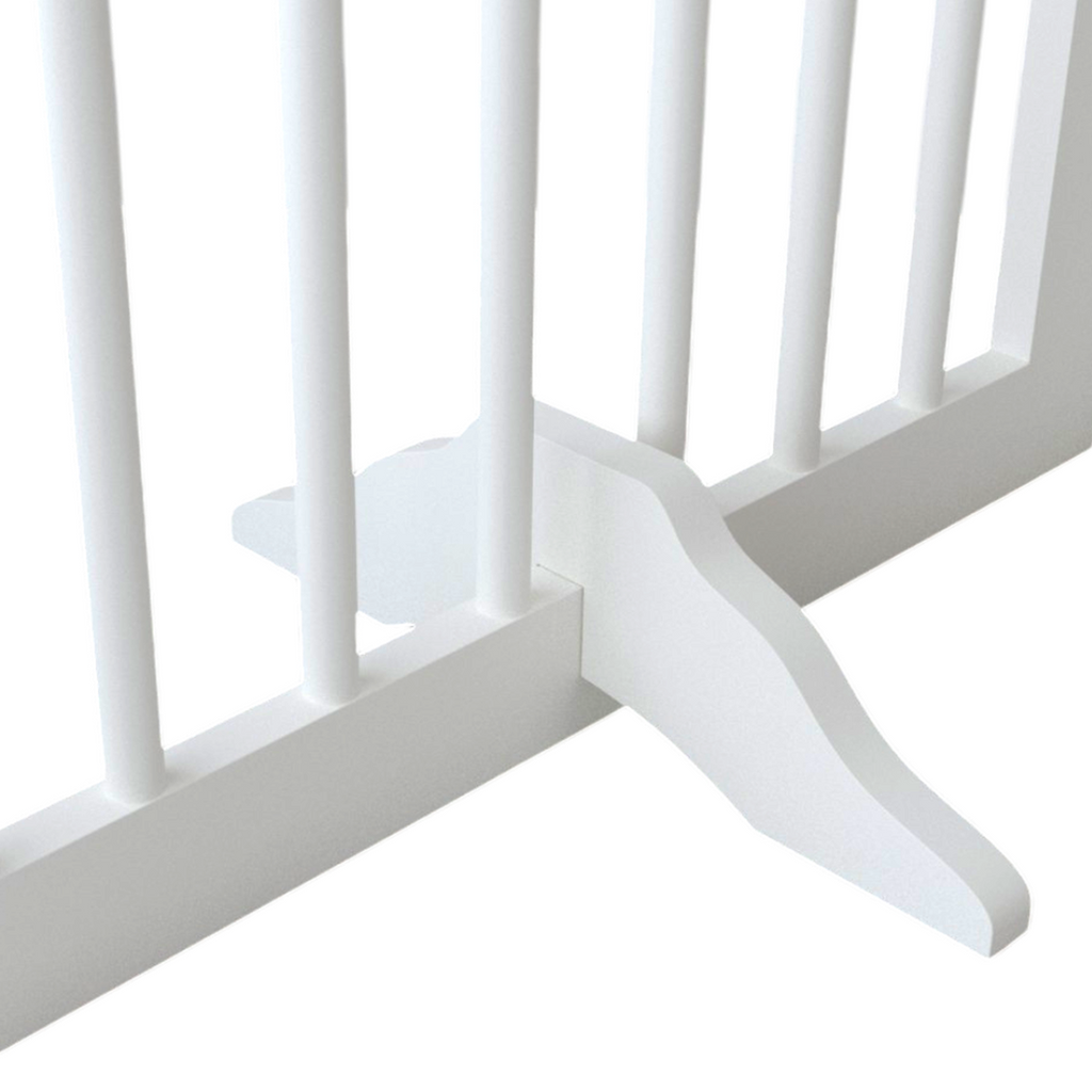 Close-up of a white crib with slatted design on a light gray background