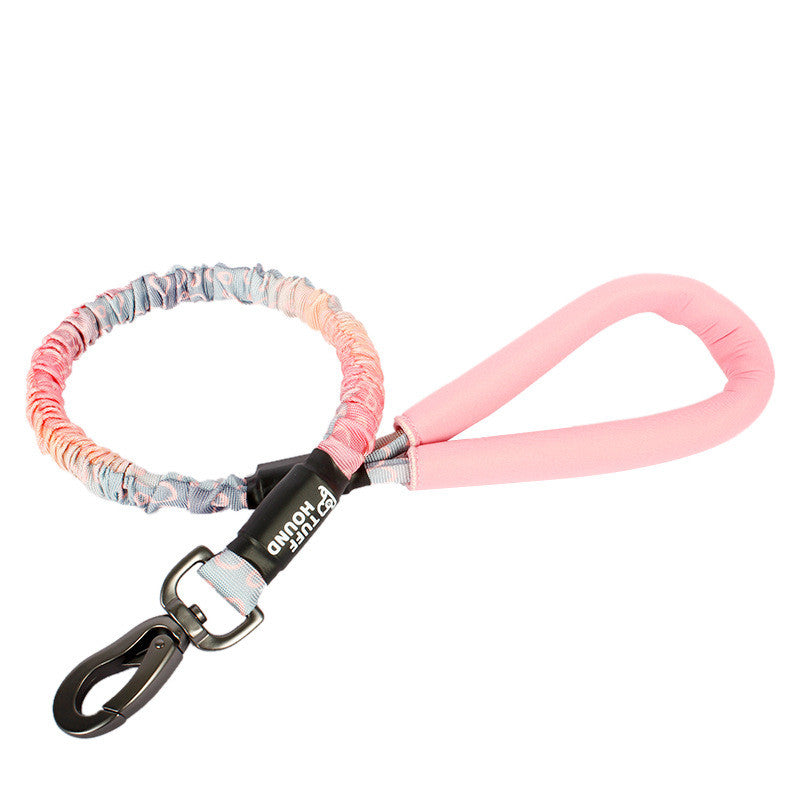 Dog leash with colorful pattern and pink handle on a white background