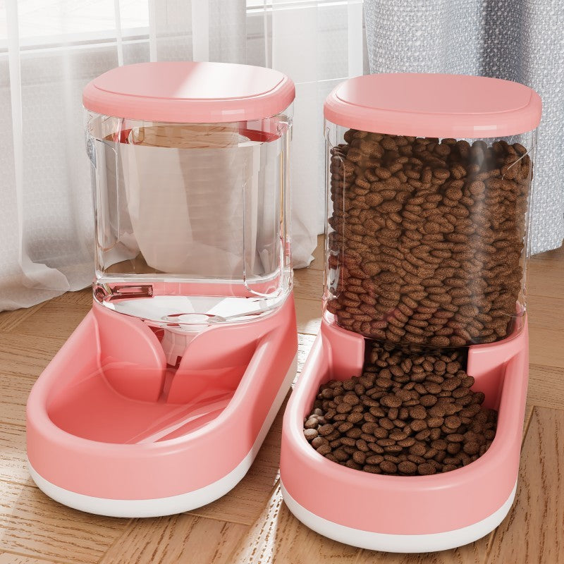 Pink pet feeder with clear container on a wooden surface