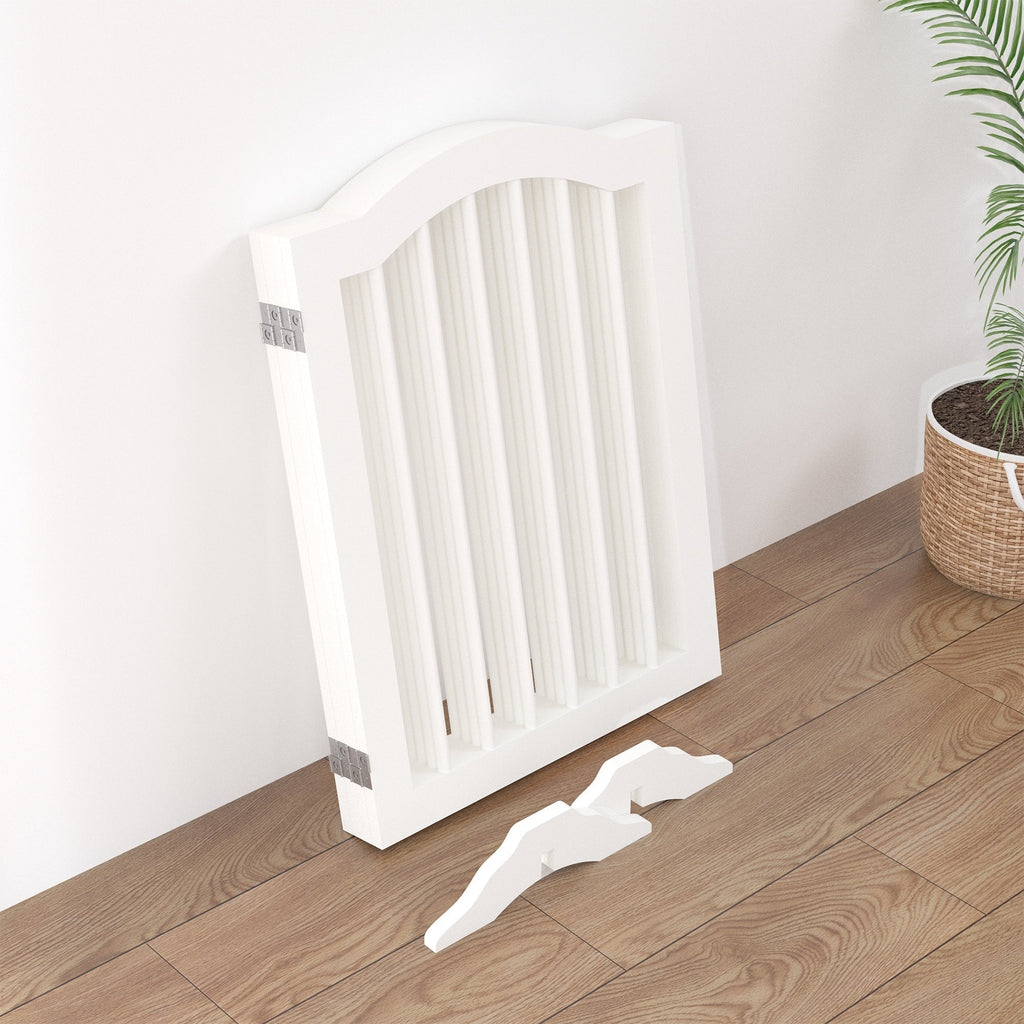 White radiator on a wooden floor with a plant in the background