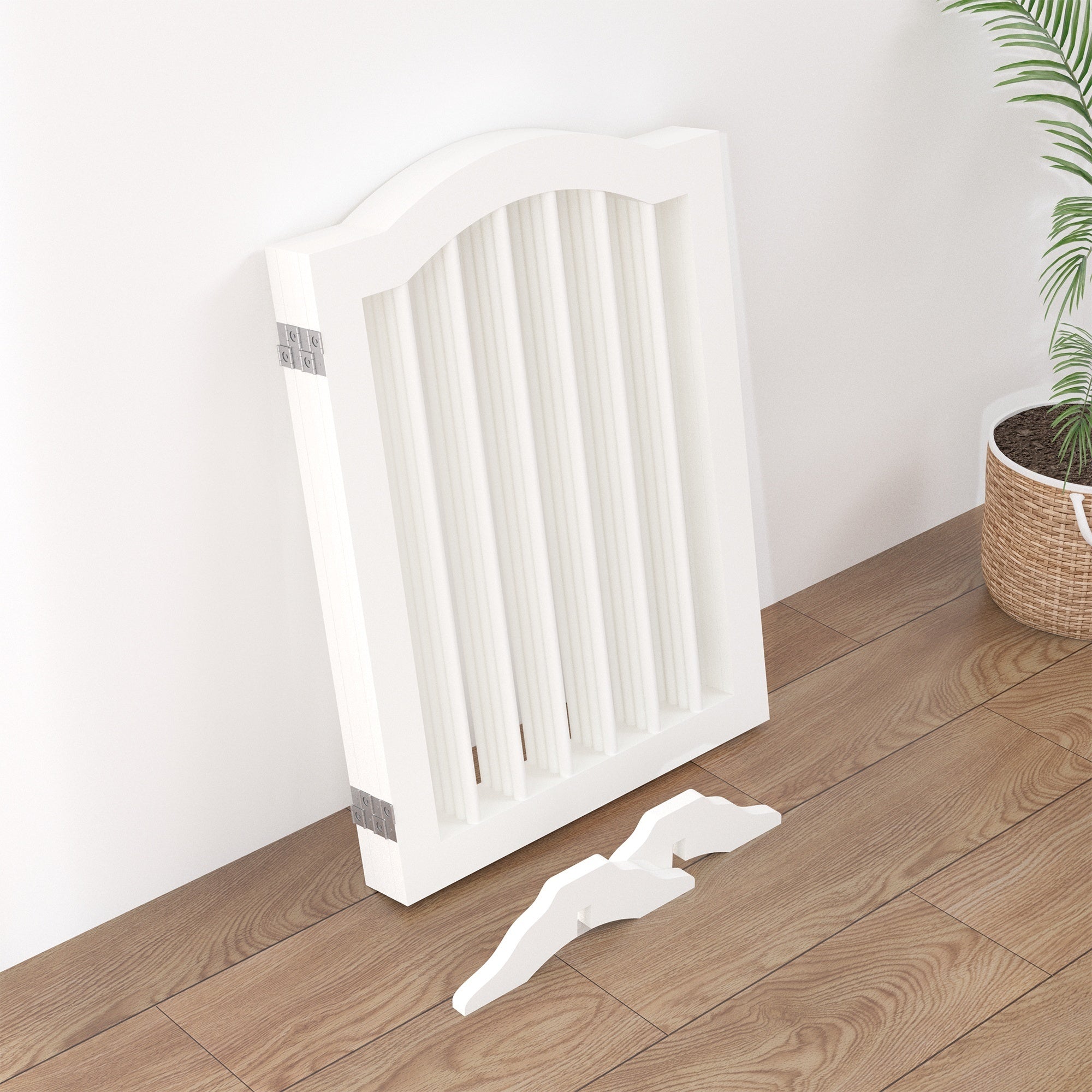 White radiator on a wooden floor with a plant in the background