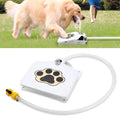 Dog drinking water from a portable water fountain on grass with a close-up of the device below.