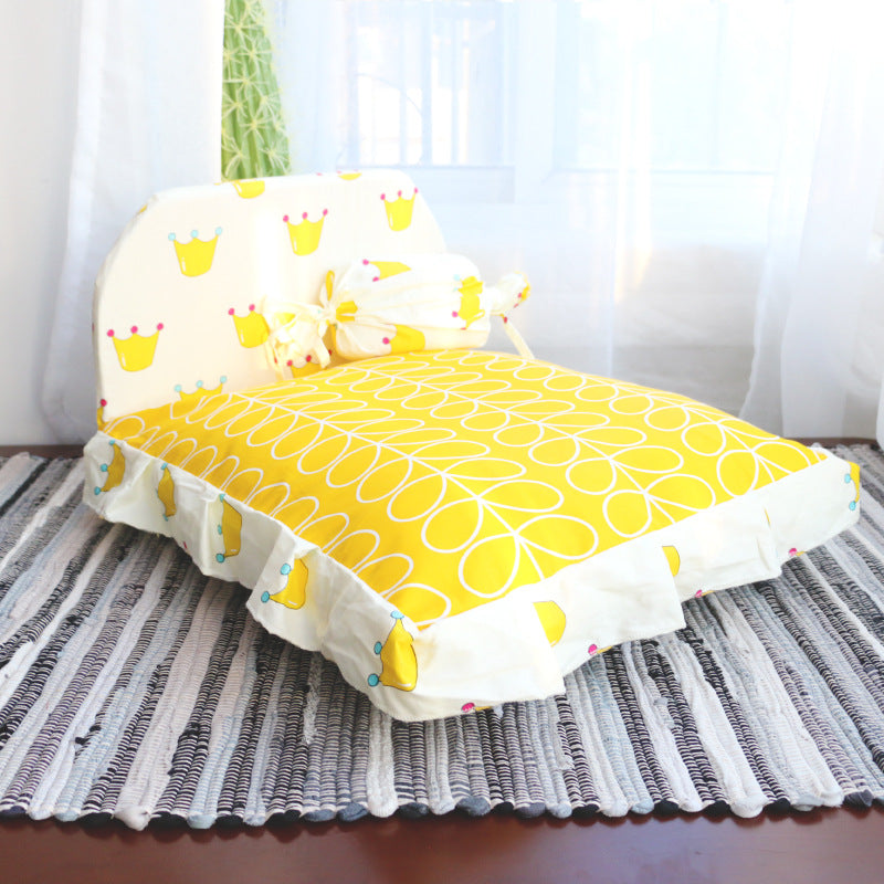 Yellow and white patterned chair on a striped rug with a blurred background