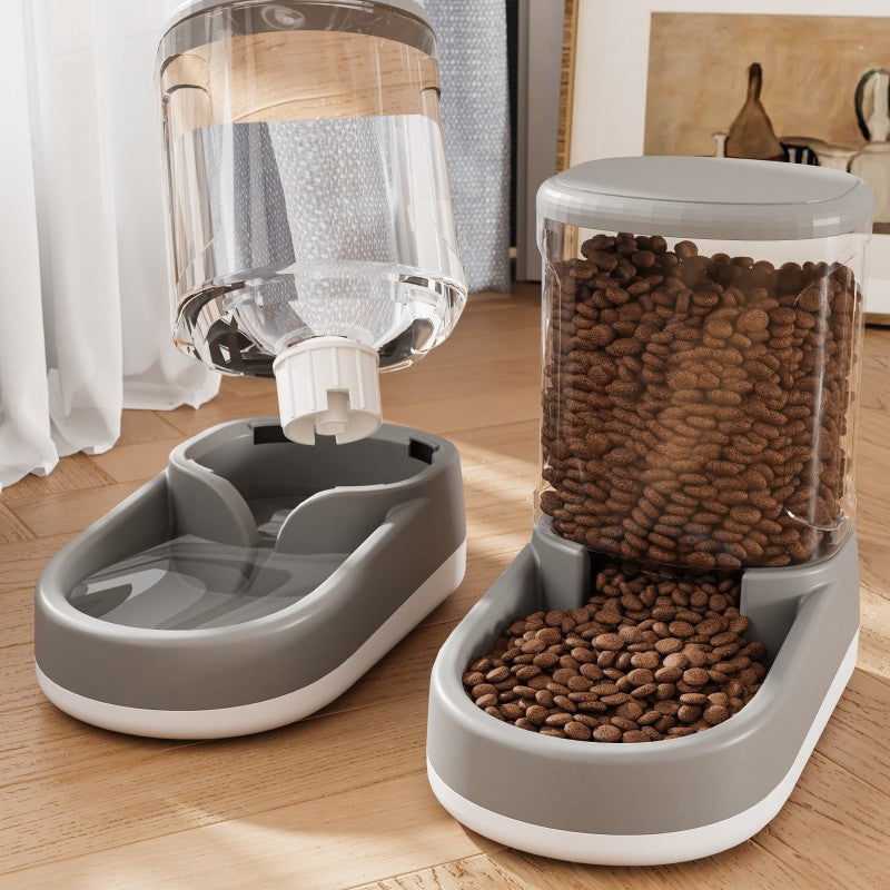 Pet feeding station with water dispenser and food container on a wooden floor.