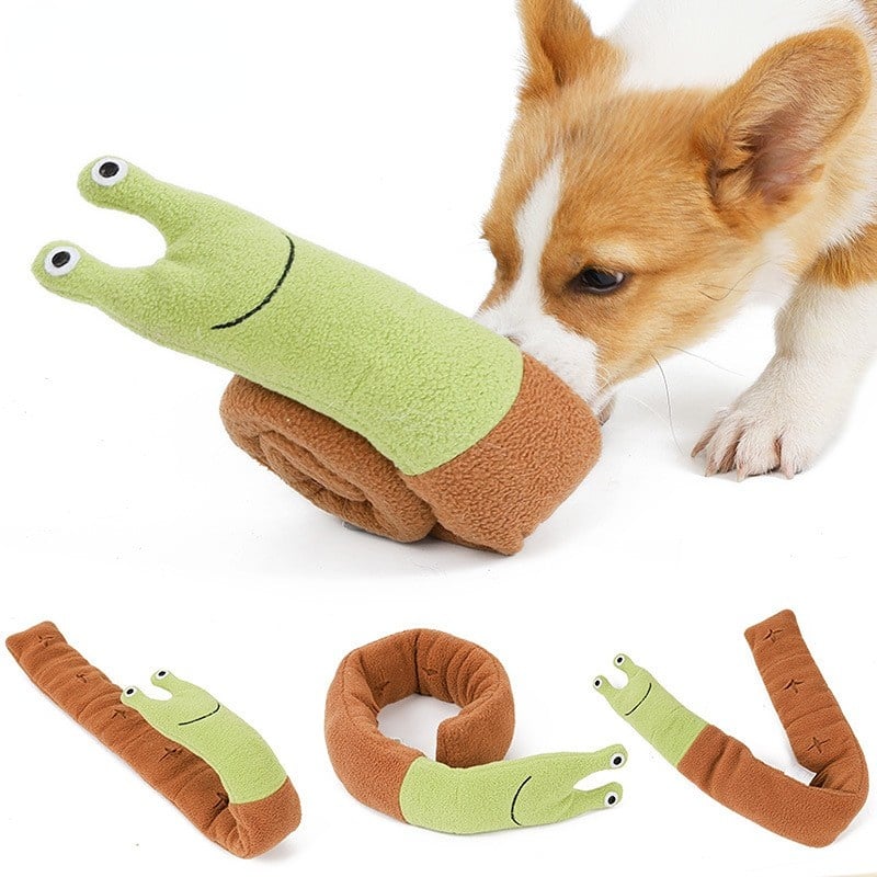 Dog playing with a green and brown toy shaped like a snake on a white background