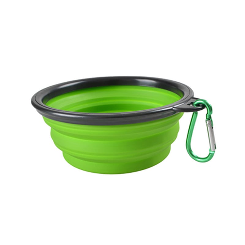 Green collapsible dog bowl with black rim and carabiner on a white background