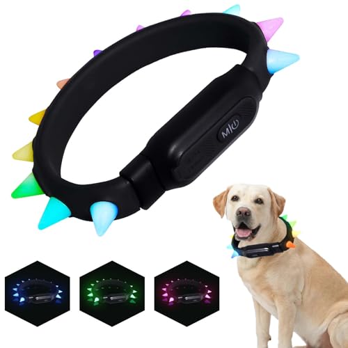 Black spiked dog collar with colorful spikes and a dog wearing it on a white background