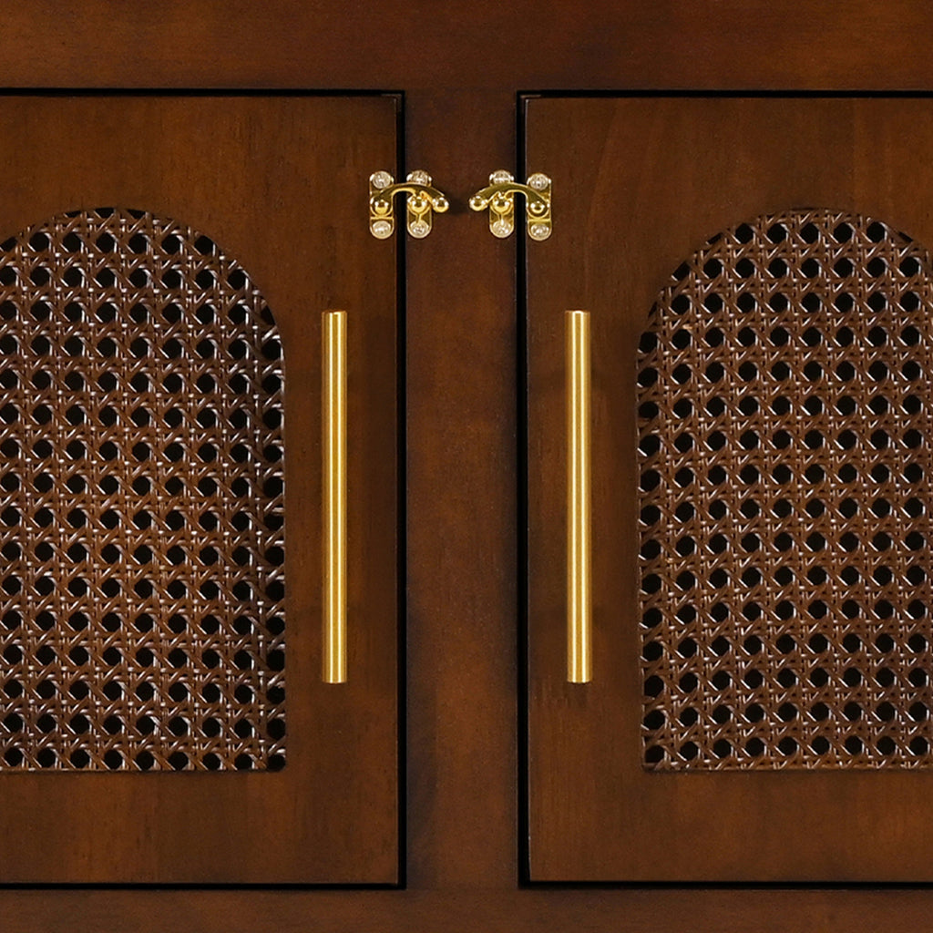 Wooden cabinet doors with decorative handles and intricate patterns.