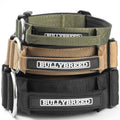 Stack of Bullybreed dog collars in green, brown, and black on a white background