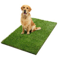 Dog sitting on a green artificial grass mat for potty training