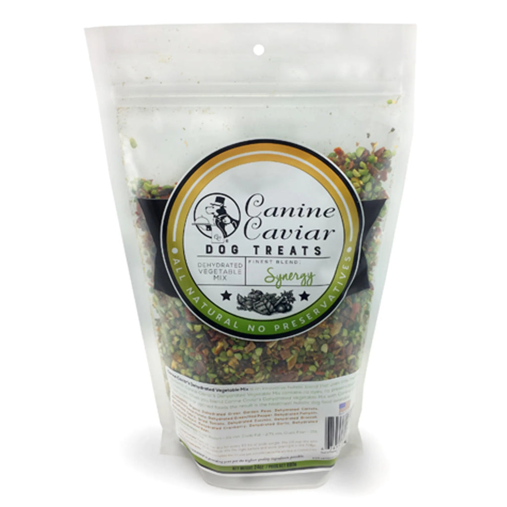 Bag of Canine Caviar dog treats with a label on a white background
