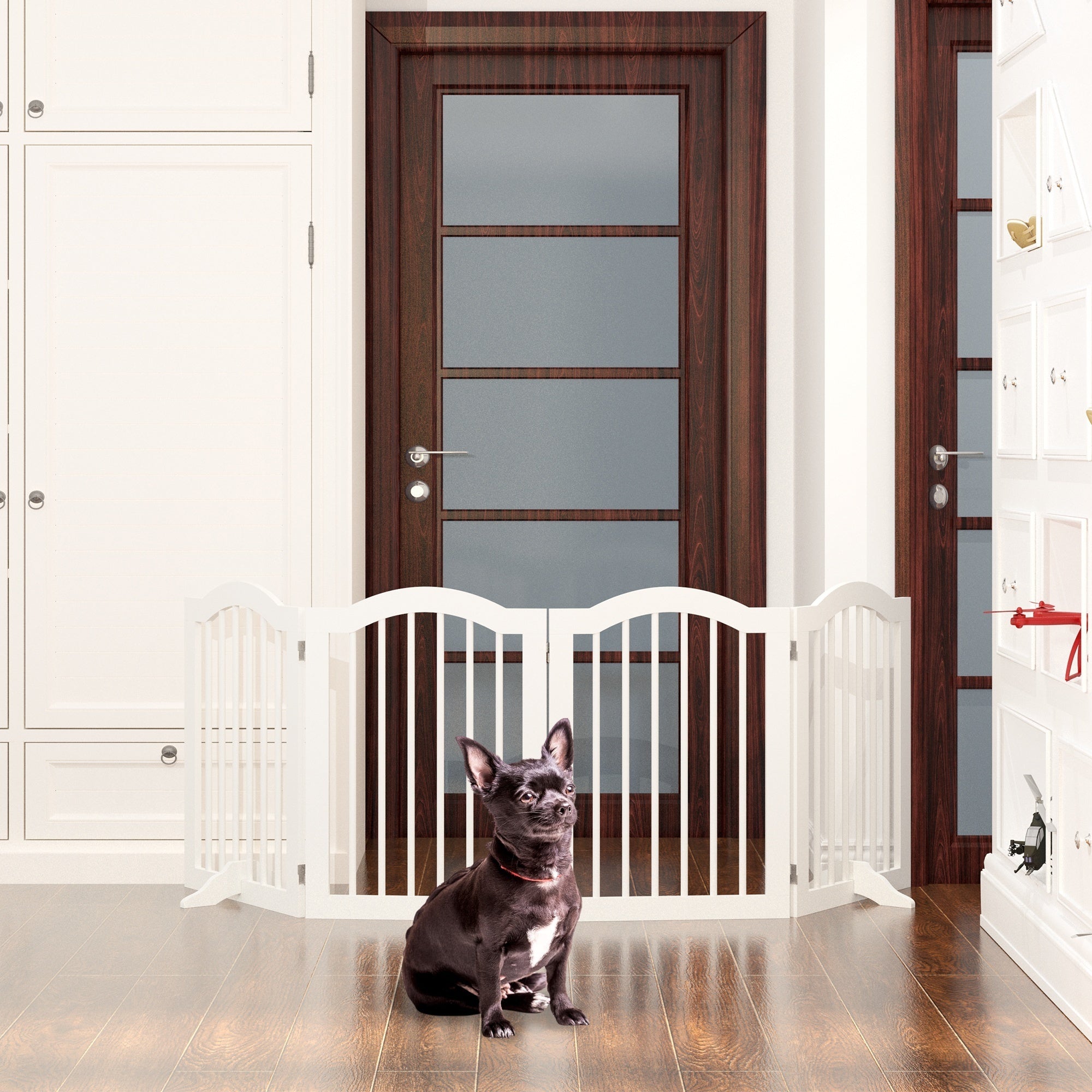 Dog sitting behind a white baby gate in a home setting