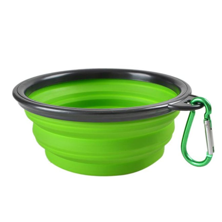 Green and black collapsible dog bowl with a carabiner on a white background