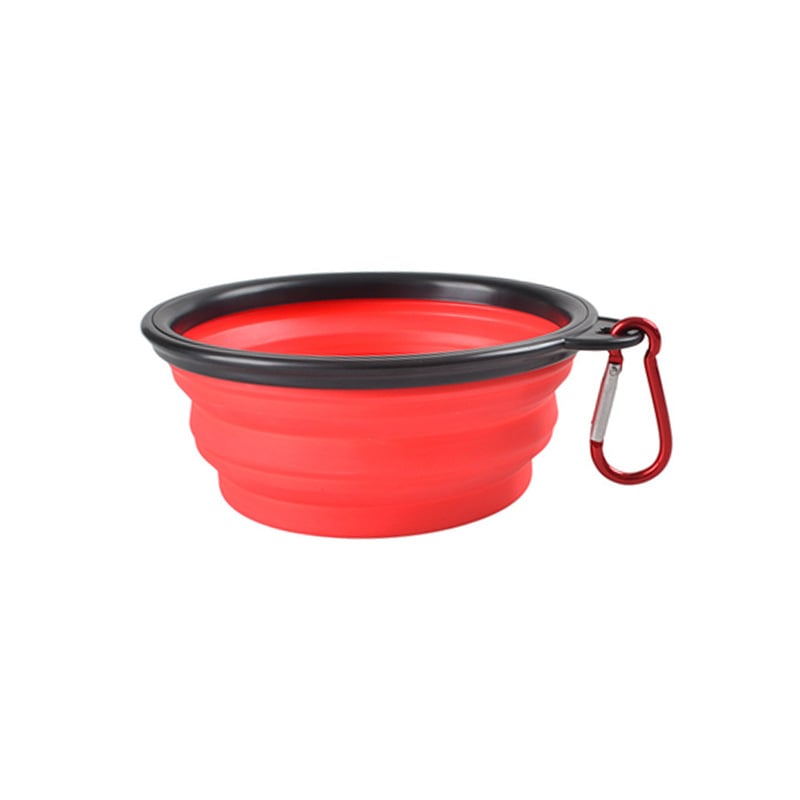 Red silicone travel bowl with black rim and carabiner on a white background