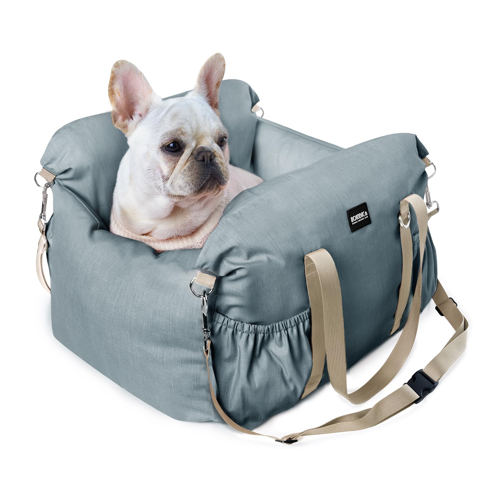 Dog lying in a blue pet carrier with a visible brand logo on a white background