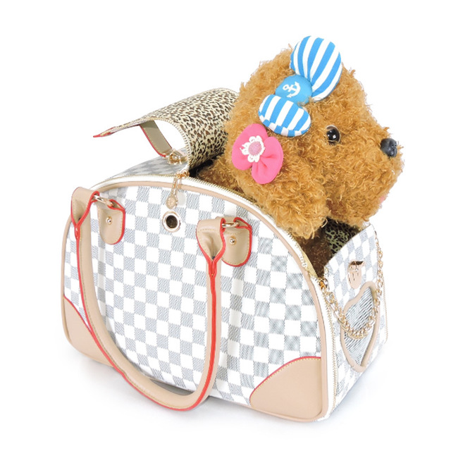 Checkered pet carrier with a small dog toy inside on a white background