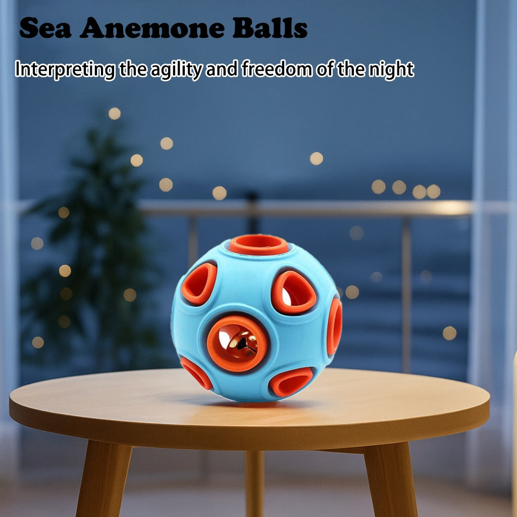 Blue and orange ball toy on a wooden table with a blurred night scene in the background