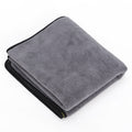 Gray towel with black edge on a white background
