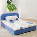dog bed with blue frame and cartoon mattress in a room with a plant.