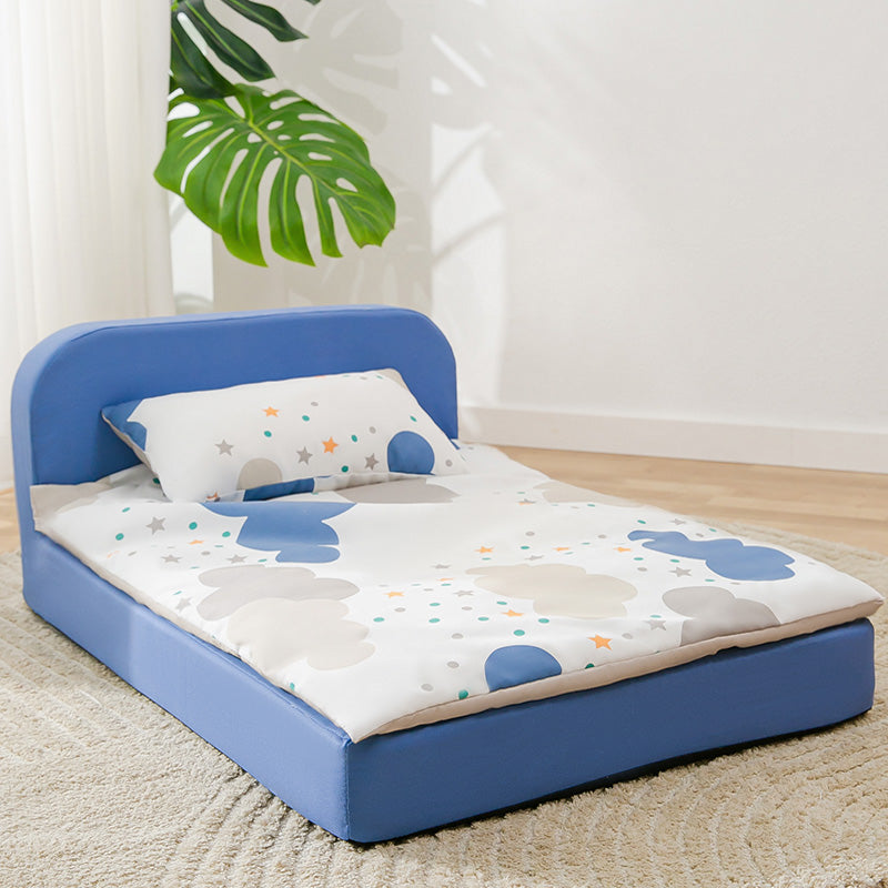 dog bed with blue frame and cartoon mattress in a room with a plant.