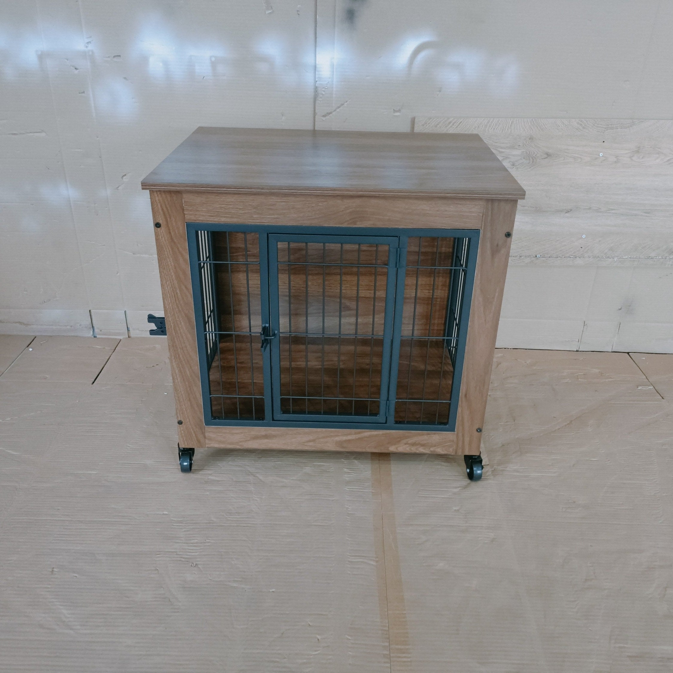 Wooden pet crate with metal bars on a tiled floor against a white wall.