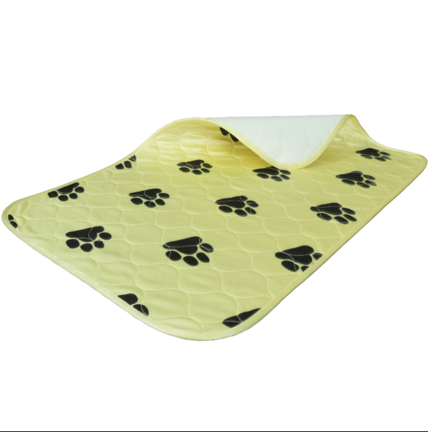 Yellow pet bed with black paw prints on a white background