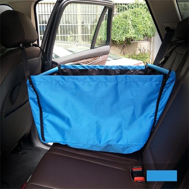 Blue pet barrier in a car's back seat