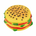 Toy resembling a hamburger with yellow bun, red sauce, and green leaves on a white background