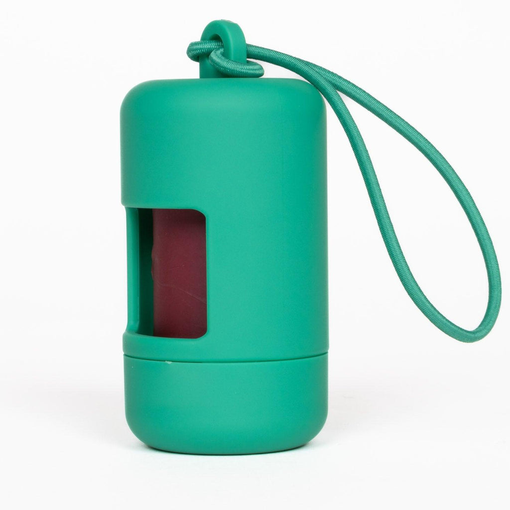 Green silicone lip balm case with a string on a white background